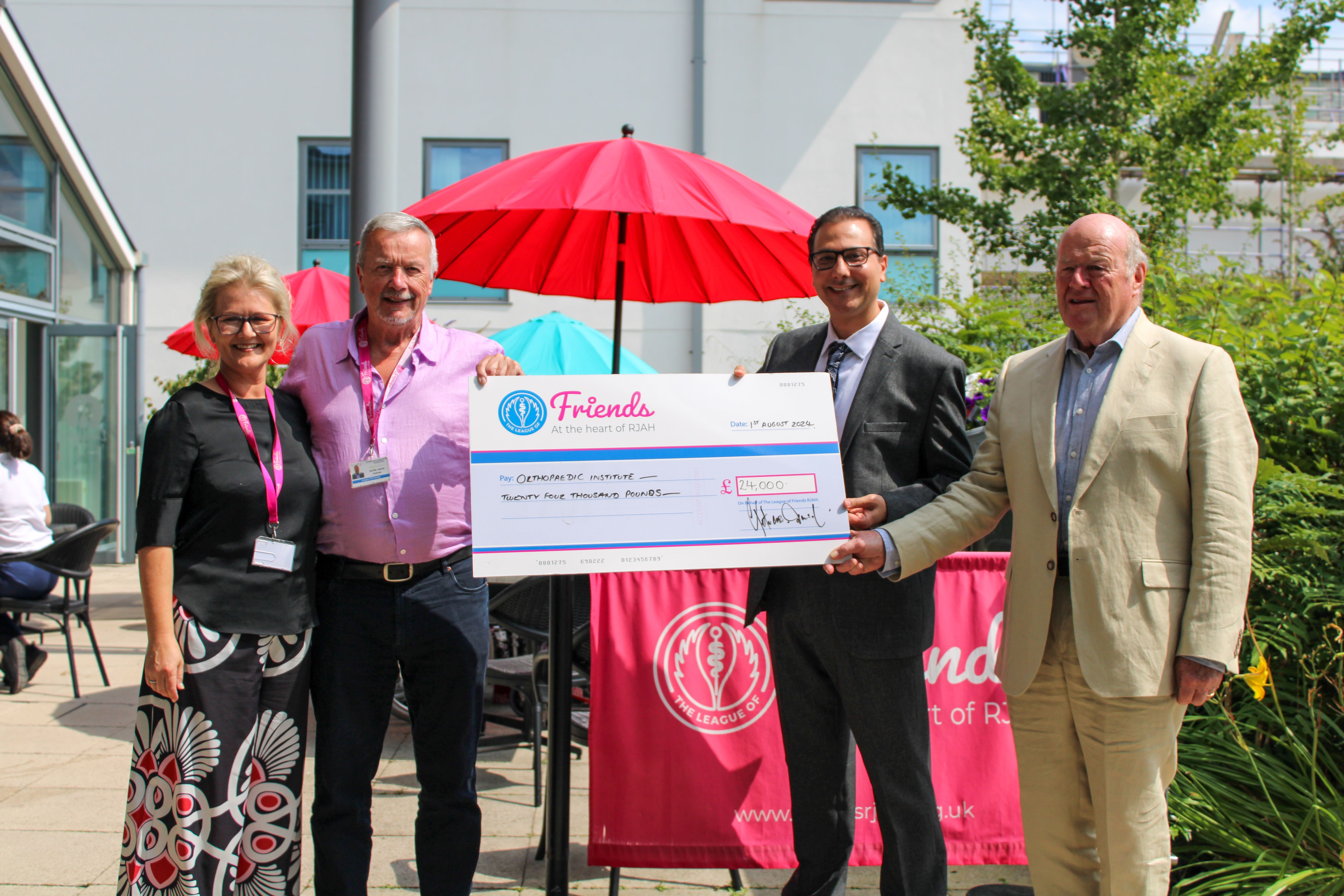 Dr Chadi Rekieh receiving a charity cheque from The League of Friends