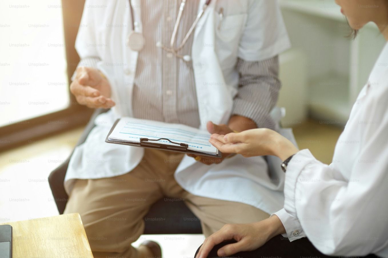 A medical professional holding a clipboard of forms