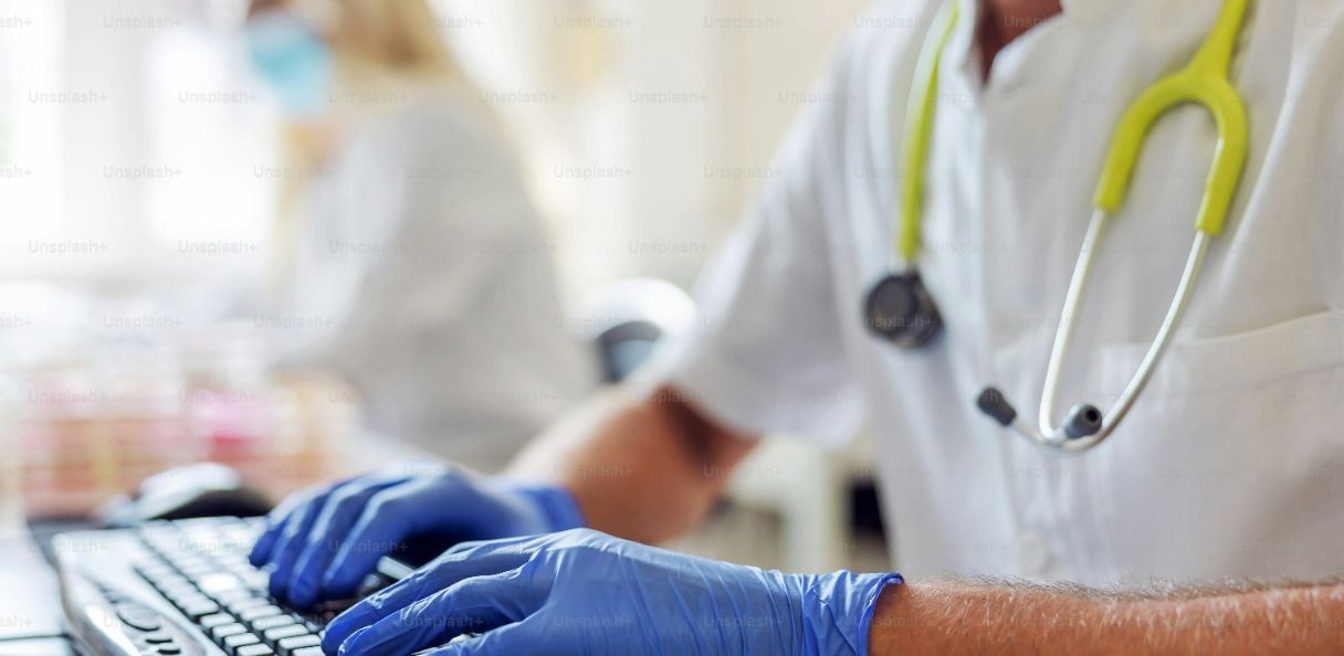 Stock image of medical professional typing
